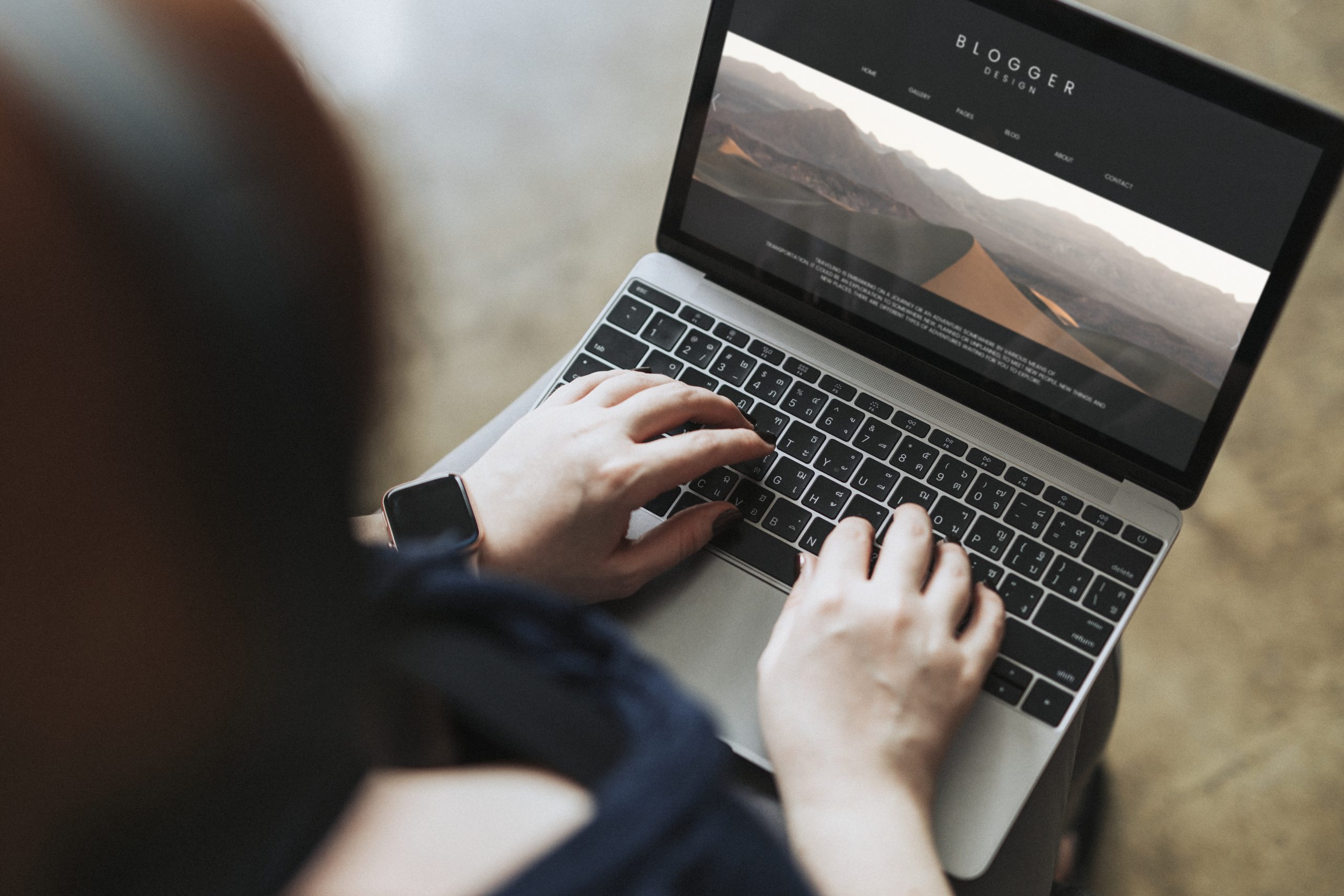 Blogger typing onto a computer screen