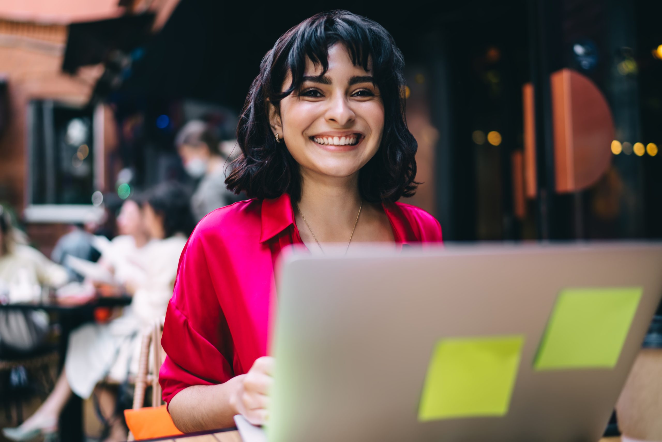 Female digital nomad working remotely in cafe
